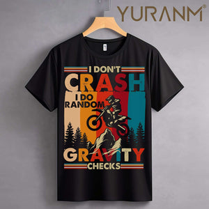 "Black T-shirt with retro motorcycle graphic and text saying 'I Don't Crash, I Do Random Gravity Checks.'"