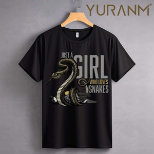 Black t-shirt with snake graphic and text "Just a girl who loves snakes" hanging against a gray background.