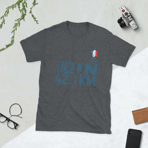 Dark Heather Olympic Games Paris 2024 short-sleeve unisex t-shirt with 42.1KM run design laid on a flat surface with camera and accessories