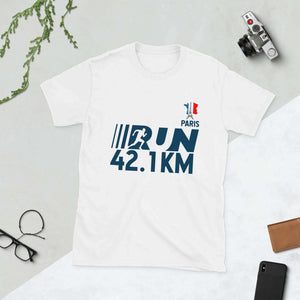 "Olympic Games Paris 2024 short-sleeve unisex t-shirt with 42.1 km run design on table with camera and glasses"