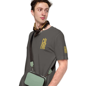 Unisex CAL FIRE firefighter T-shirt honoring brave heroes, model wearing gray tee with yellow logo and carrying a crossbody bag.