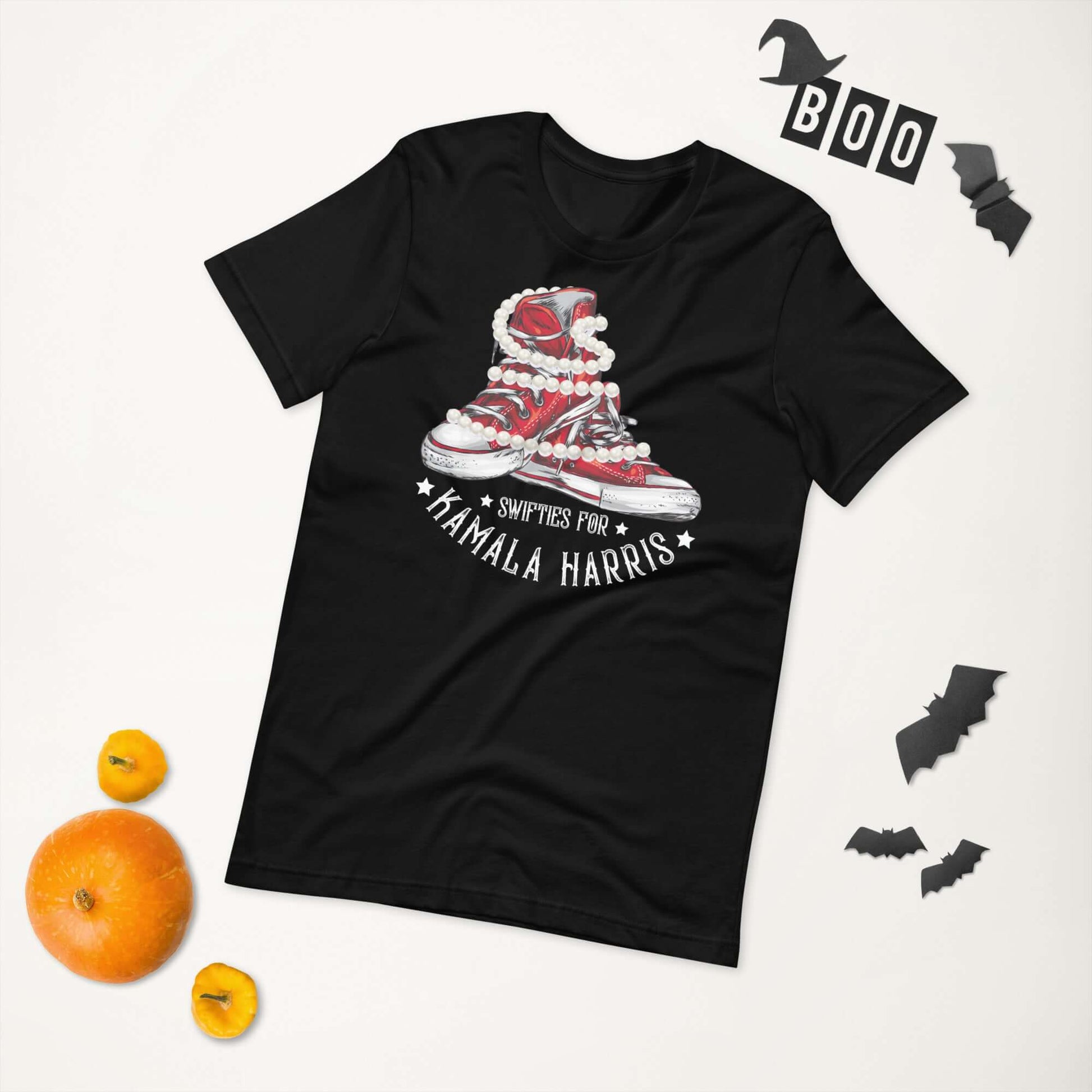 Swifties for Kamala Harris Chucks and Pearls VOTE unisex black t-shirt with Halloween decorations.