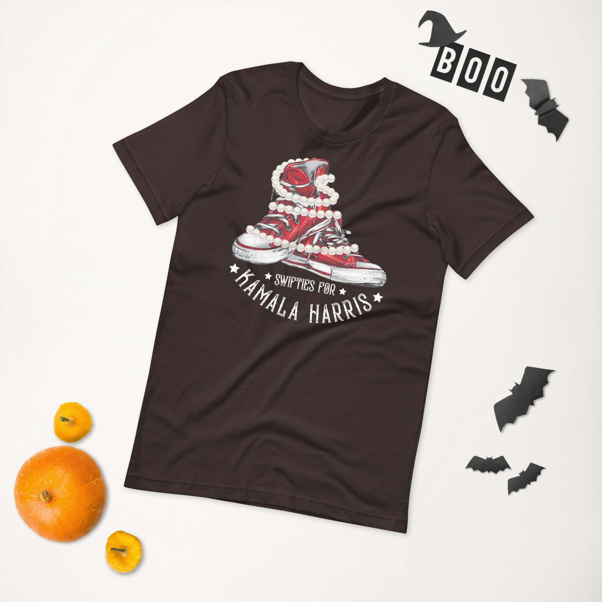 Swifties for Kamala Harris Chucks and Pearls VOTE unisex t-shirt on a flat lay with Halloween decorations