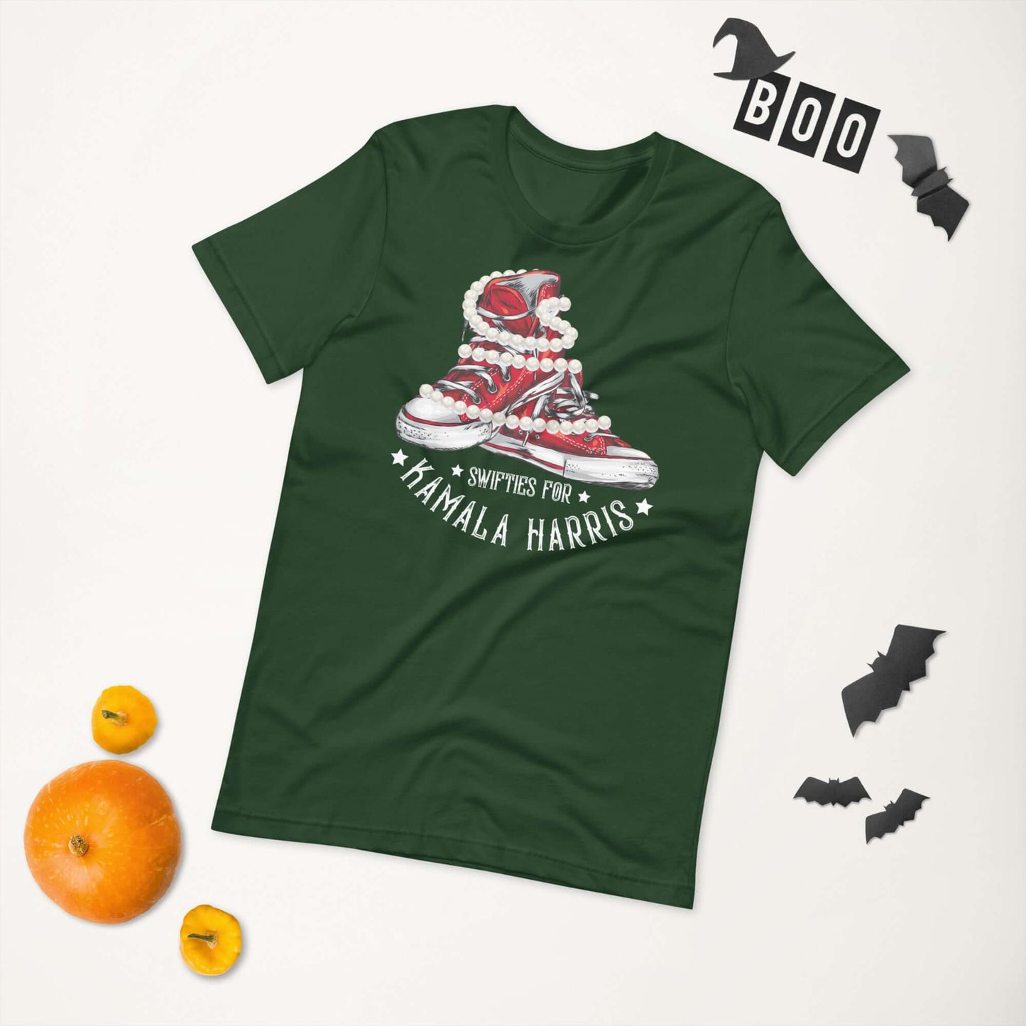 Swifties for Kamala Harris Chucks and Pearls VOTE unisex t-shirt in green, Halloween-themed flat lay with pumpkins and bats