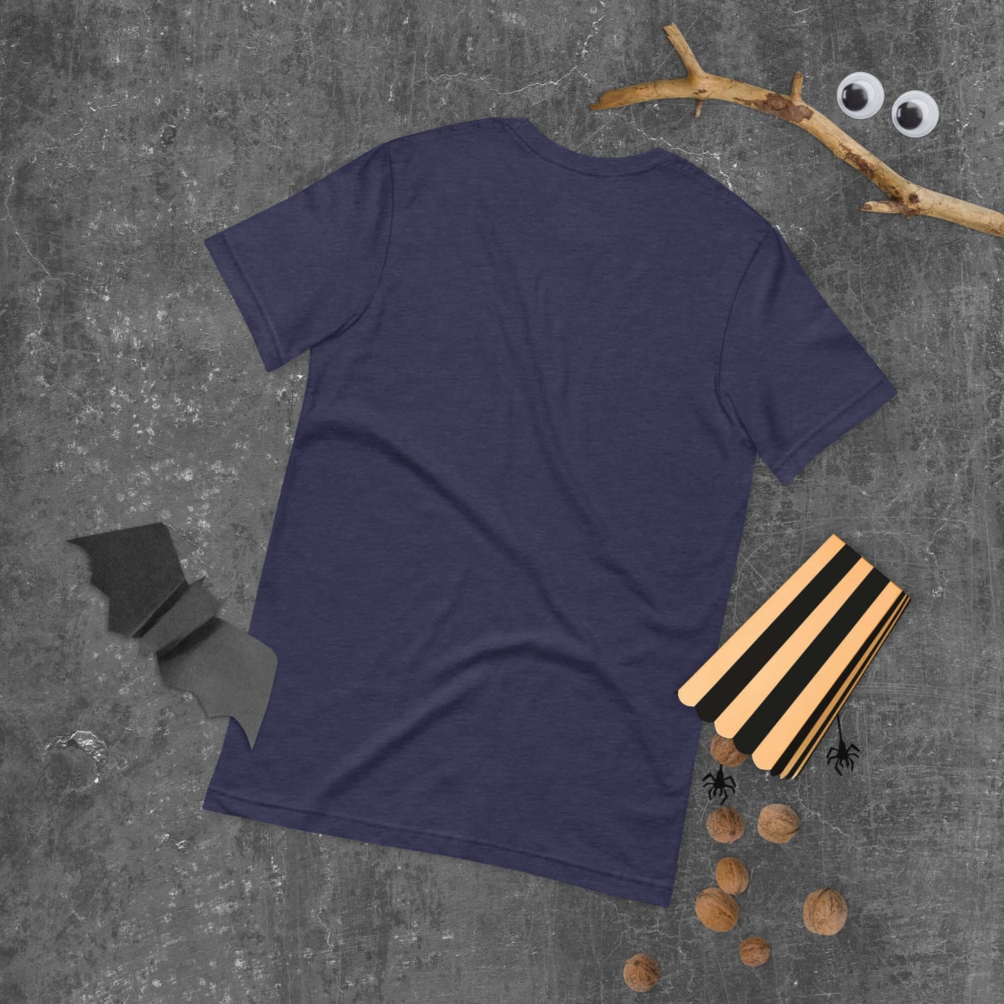 Purple unisex t-shirt with playful Halloween-themed props on concrete background