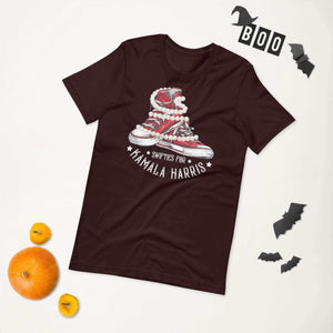 Unisex t-shirt with Swifties for Kamala Harris Chucks and Pearls design on a flat lay with Halloween decor and pumpkins.